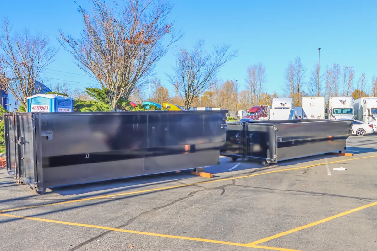 Professional dumpster rental service with roll-off container on residential driveway in Hoosick